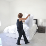 Person staging bedroom while preparing to sell home